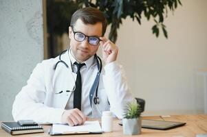 Male doctor working in clinic photo