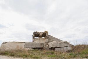 the ruins of german bunker in the beach of Normandy, France photo