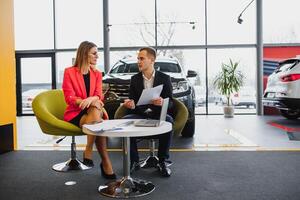 Woman buying the car and seller selling photo