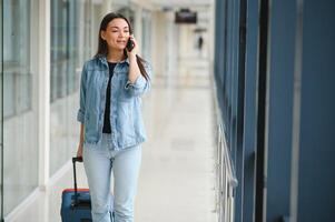 Pretty young female passenger at the airport photo