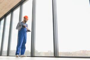 service man installing plastic window. photo