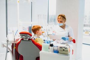 Female dentist and child in a dentist office photo