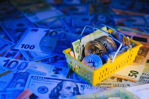 Close up heap of golden bitcoin physical coins on top of Euro, dollar banknotes background, high angle view, selective focus photo