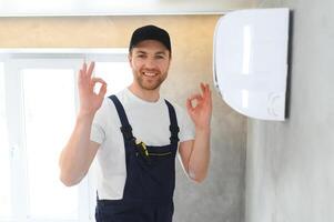 Service man is cleaning, repair and maintenance of air conditioner. photo