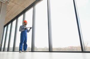 service man installing plastic window. photo