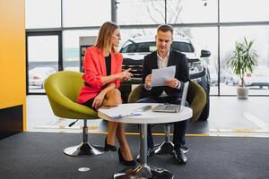 business woman buys a car at a car dealership. Concept of happy business people photo