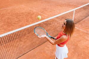 Woman in sportswear plays tennis at competition photo