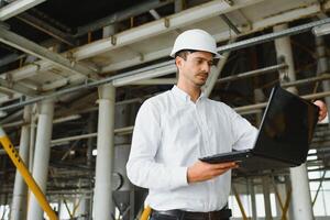 happy male industrial technician inside a factory photo