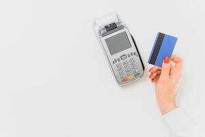 Close up of hand using credit card swiping machine to pay. credit card payment through a shopping terminal. Credit card payment for new clothing collection photo