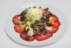 Fresh salad with vegetables and cheese on a white background photo