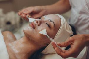 woman at the cosmetologist. She has problem skin and acne. photo