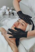 A girl at a cosmetologist does cosmetic procedures. Skin cleansing photo