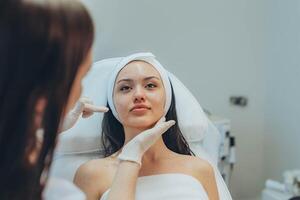 girl at a cosmetologist's office doing skin cleansing photo