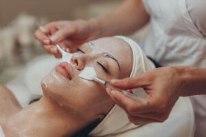 woman at the cosmetologist. She has problem skin and acne. photo