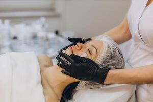 woman at the cosmetologist. She has problem skin and acne. photo