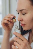 A female cosmetologist doctor smells cosmetics in her beauty salon photo