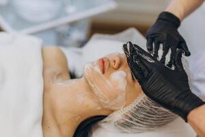 woman at the cosmetologist. She has problem skin and acne. photo