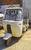 Puerto Escondido Oaxaca Mexico 2023 White tuk tuk tricycle TukTuks rickshaw in Mexico. photo