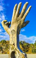 Puerto Escondido Oaxaca Mexico 2022 Hands stone rock statue sculpture beach Puerto Escondido Mexico. photo