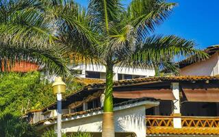 Hotels resorts buildings in paradise among palm trees Puerto Escondido. photo