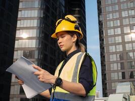 Yellow orange color hardhat safety helmet engineer labor safety occupation architecture construction project site helmet labor day may september july month blue print development manger industry site photo