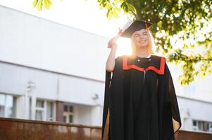 Portrait of a happy woman on her graduation day at university. Education and people. photo