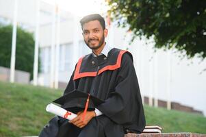 education, graduation and people concept - happy Indian Male graduate student. photo