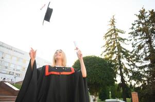 A young female graduate against the background of university. photo