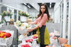 hermosa joven florista en flor tienda foto