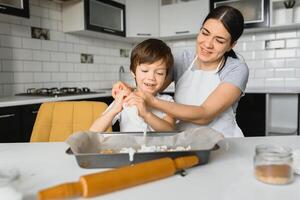 Happy mother and little son in the kitchen, happy time and togetherness photo