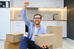 Smiling guy moving into his new home photo