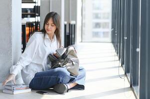 education and school concept - student girl studying and reading book at school. photo