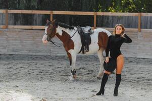 Fashionable portrait of a beautiful young woman and horse photo