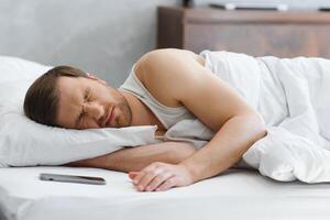 Young man in bed , trying to sleep photo