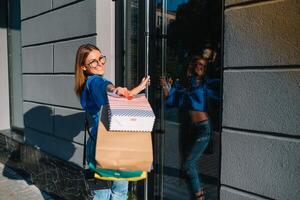 Woman in shopping. Happy woman with shopping bags enjoying in shopping. Consumerism, shopping, lifestyle concept photo