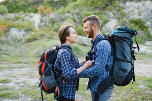 happy young couple hiking in mountain photo