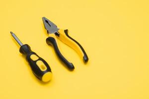 Carpenter tools set on yellow background, top view photo