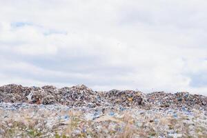 huge pile of garbage in a city dump on gloomy day. Keeping the environment clean. Ecological problems. photo