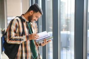 Happy indian male student at the university photo