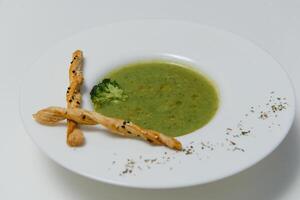 Smoothie soup with broccoli on a white background. vegetarian food photo