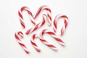 AI generated Red and white striped candy canes arranged in a flatlay design on a clean white background. Generative AI photo