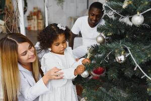 happy multiracial family with gifts at Christmas photo