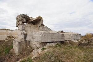 the ruins of german bunker in the beach of Normandy, France photo