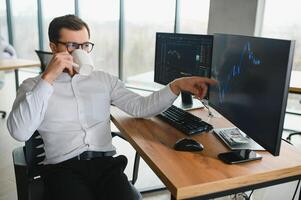 Successful trader in formalwear checking cryptocurrency information data on finance market graph, working in office photo