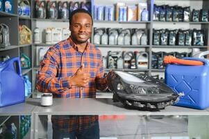 Portrait of a handsome african salesman in an auto parts store. The concept of car repair photo