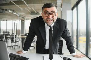 Angry businessman with document shouting at somebody photo