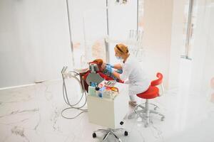 Female dentist and child in a dentist office photo