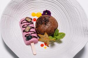 Chocolate fondant with vanilla ice cream and raspberry sauce photo