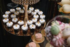 Delicious sweets on candy buffet. Table with sweets, buffet with cupcakes, Macaroons, candies, dessert photo