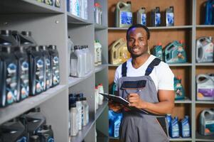 man with canister of motor oil in auto store photo